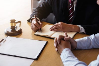 Close up of gavel, lawyer, and client